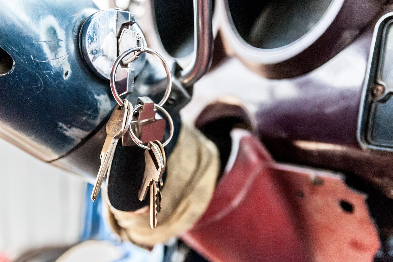 A ring of keys hanging from a vehicle's ignition