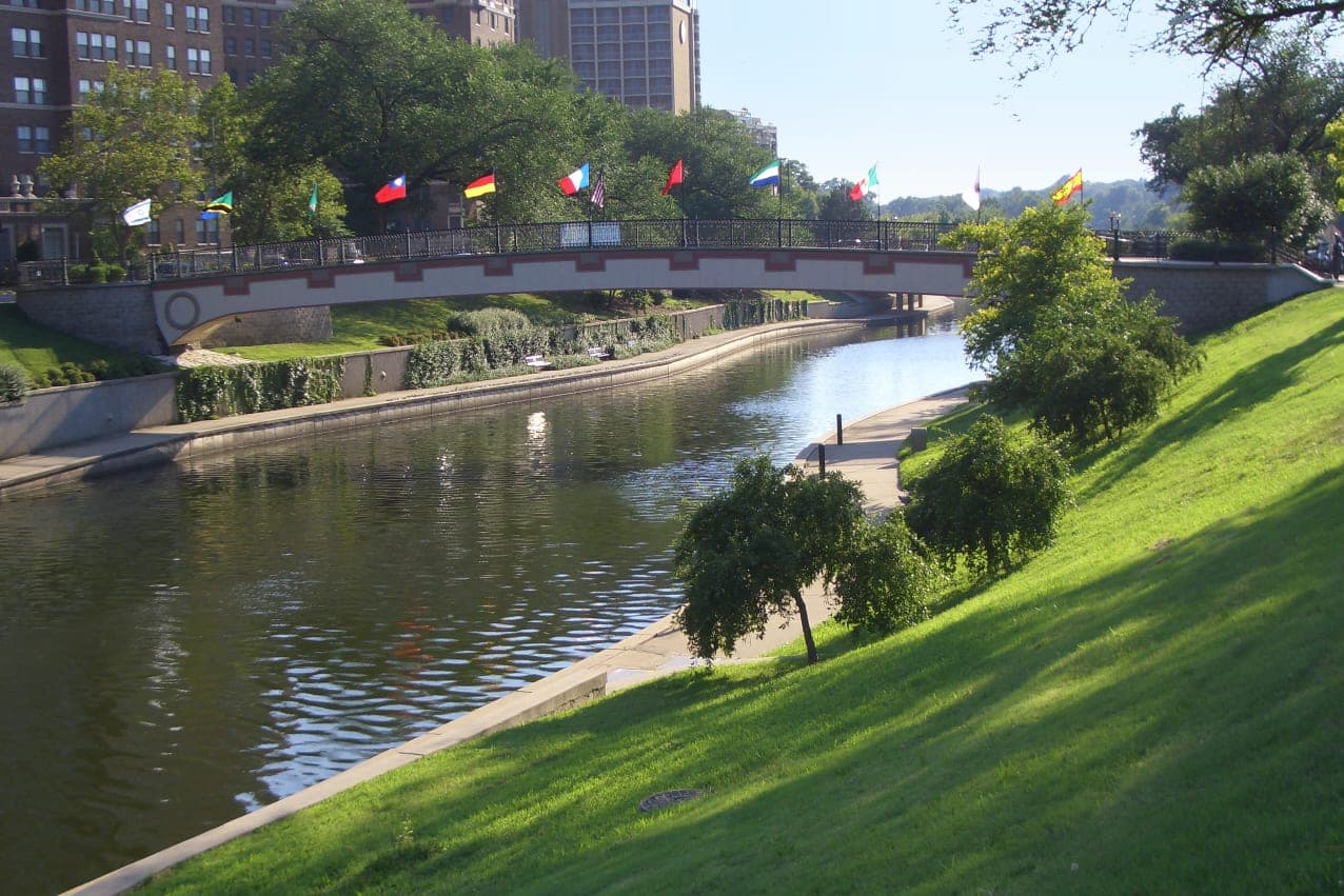 The Sister Cities Bridge, lined with flags, crosses Brush Creek in Kansas City, Missouri