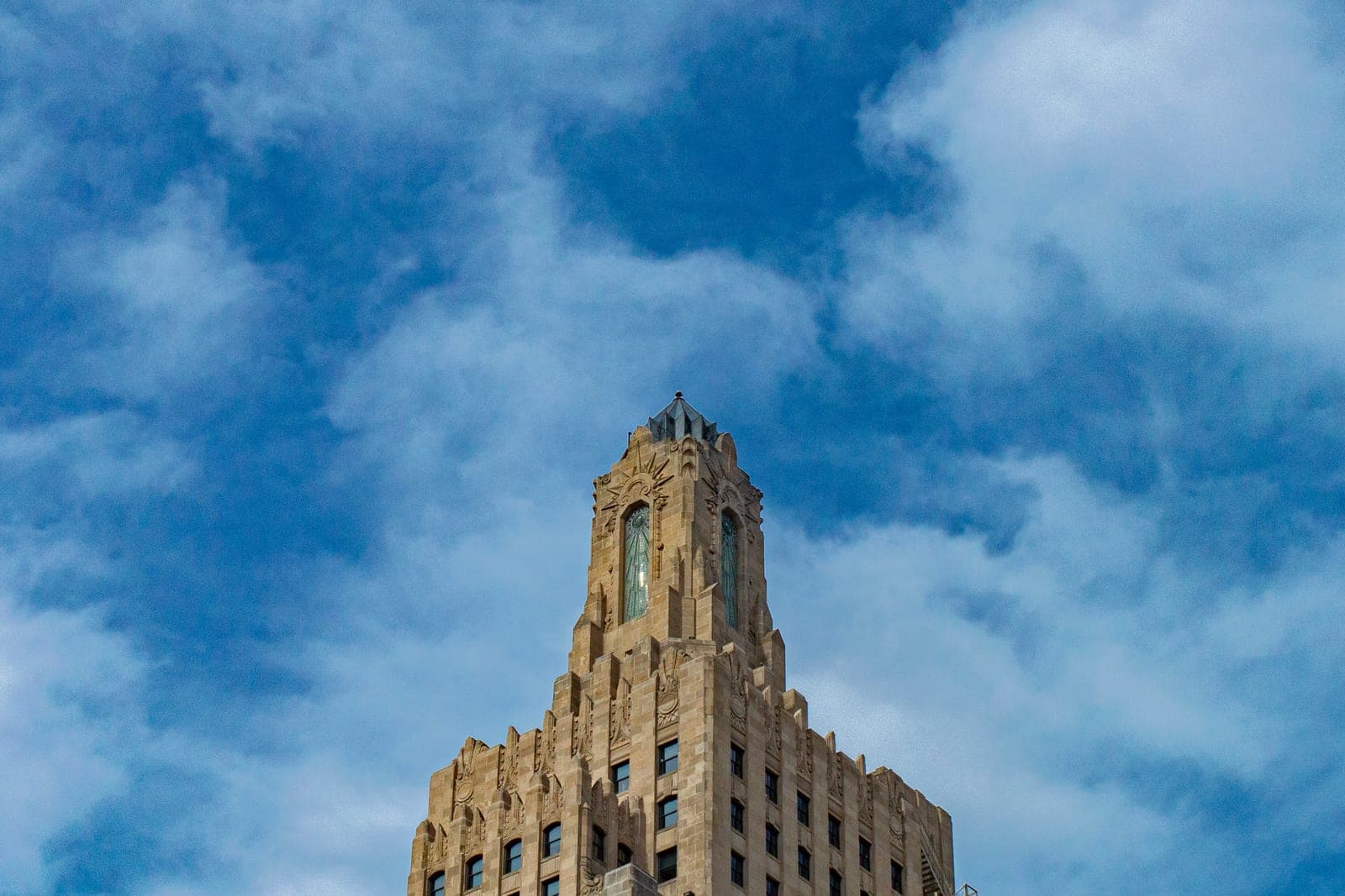 The art deco Kansas City Power & Light Building's stepped tower against a bright blue sky in Kansas City, Missouri