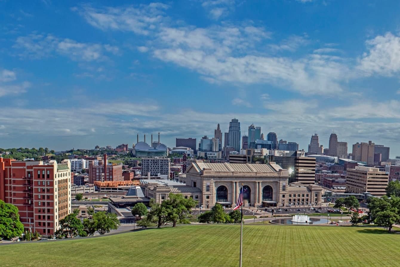 Union Station and the downtown Kansas City skyline under a blue sky with white clouds