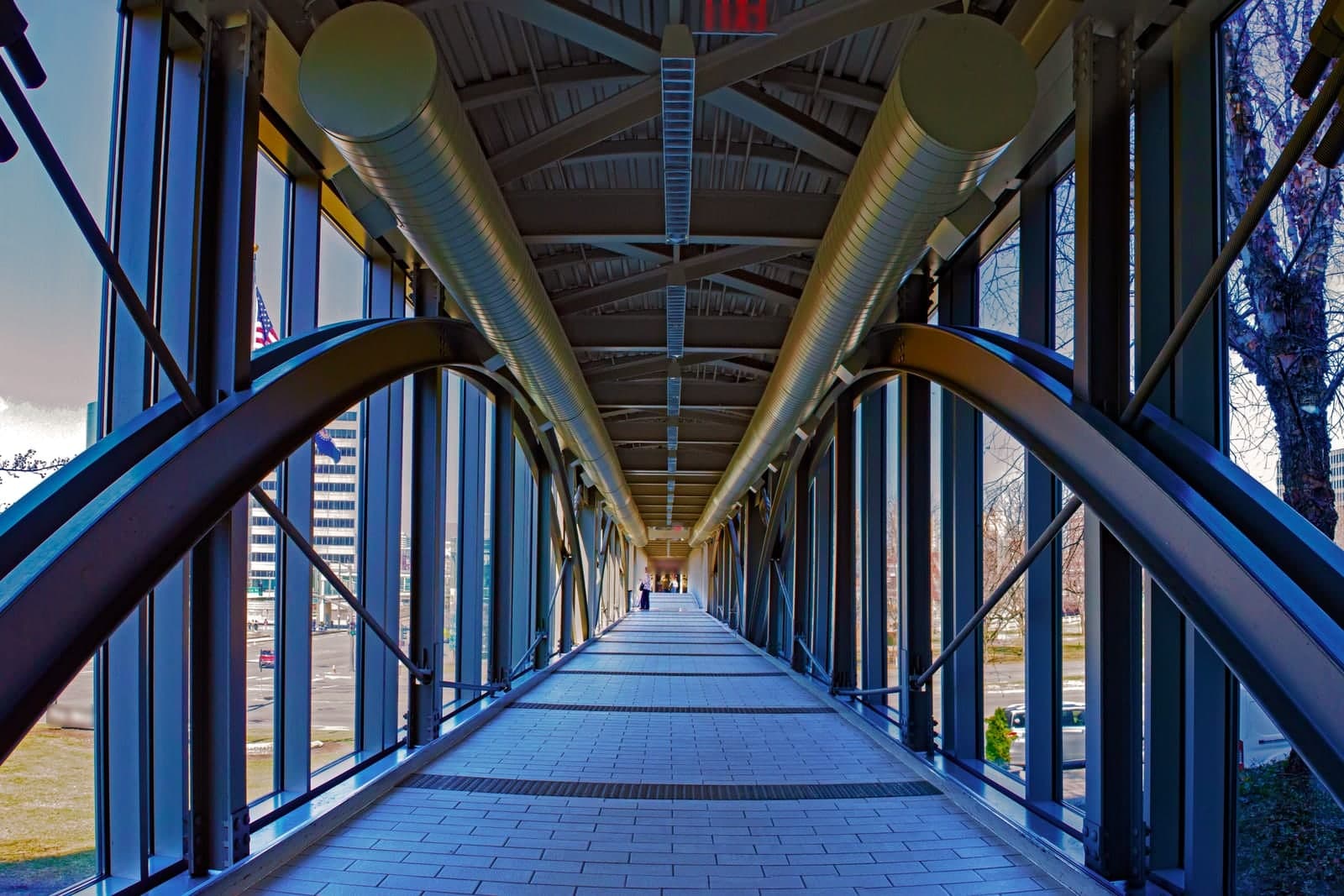 The glass-walled Link walkway, a covered pedestrian bridge in Kansas City, Missouri, seen from inside on a clear day