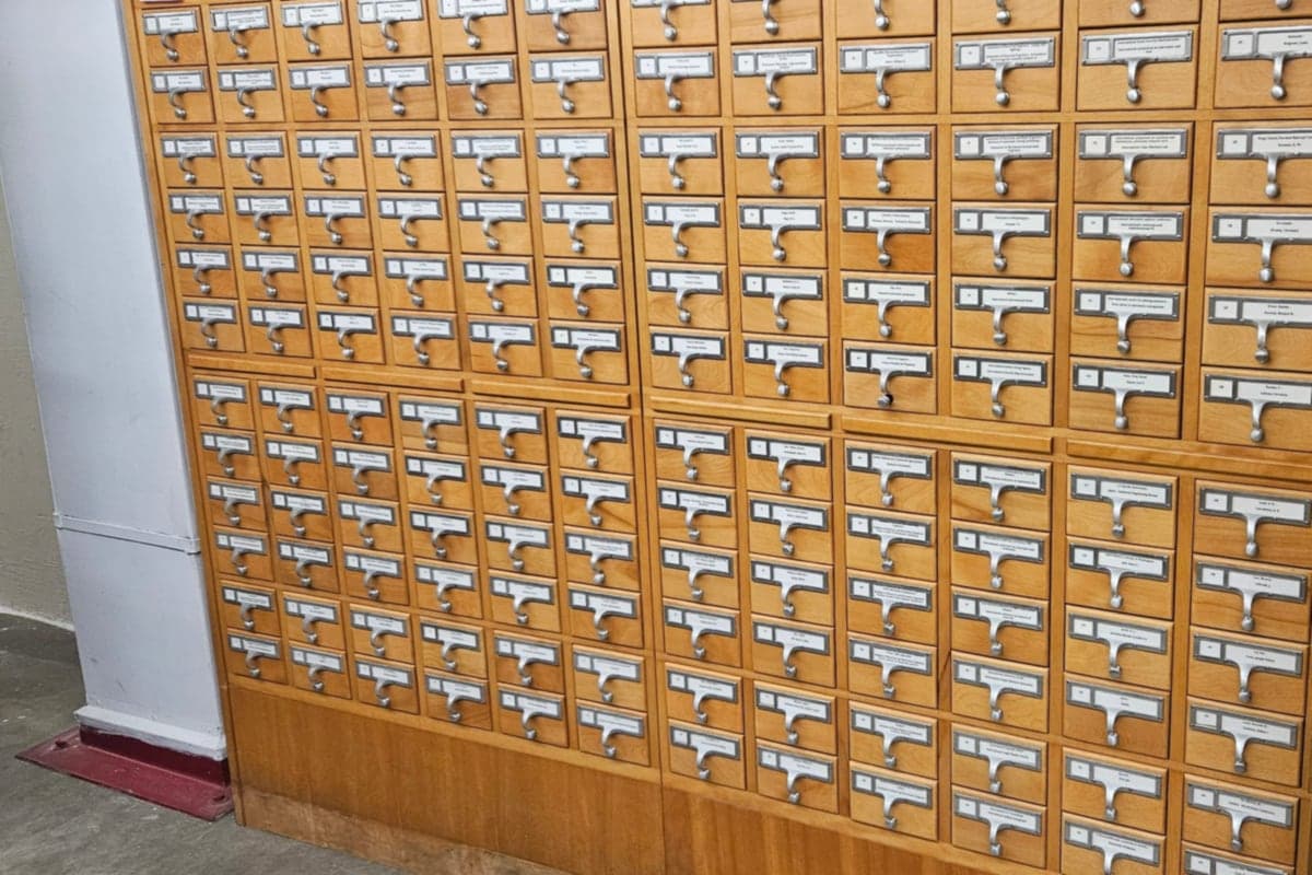 A wall of wooden card-catalog drawers with metal handles