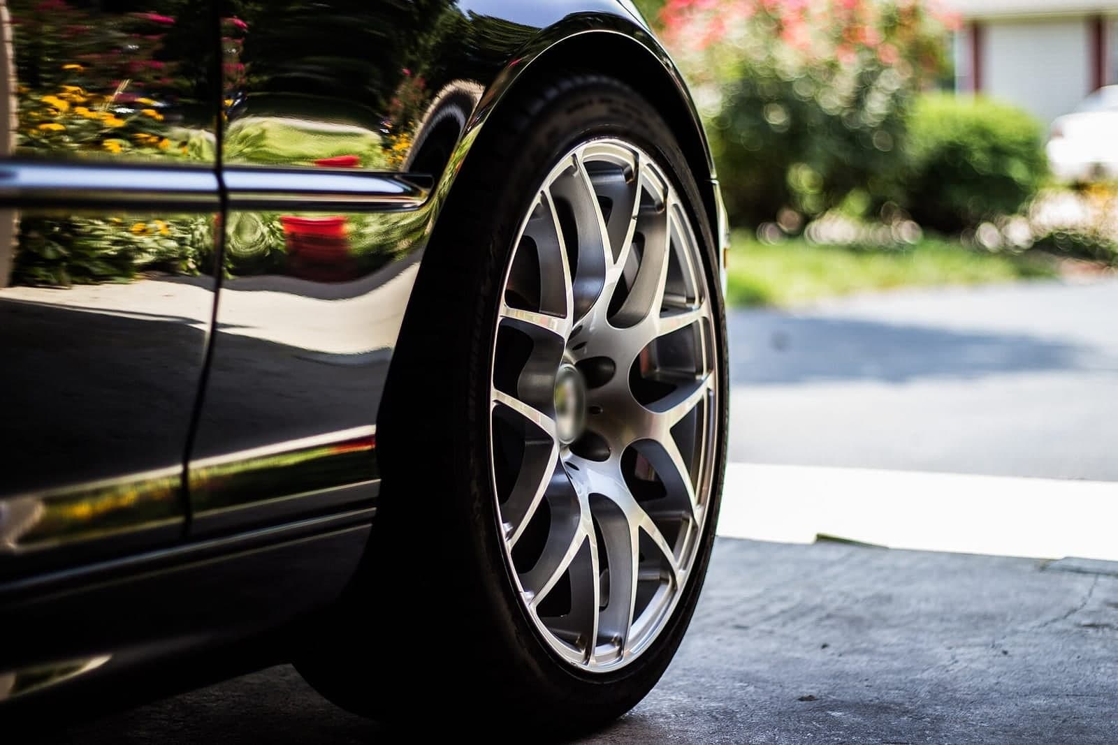 Close-up of a polished alloy wheel on a dark car