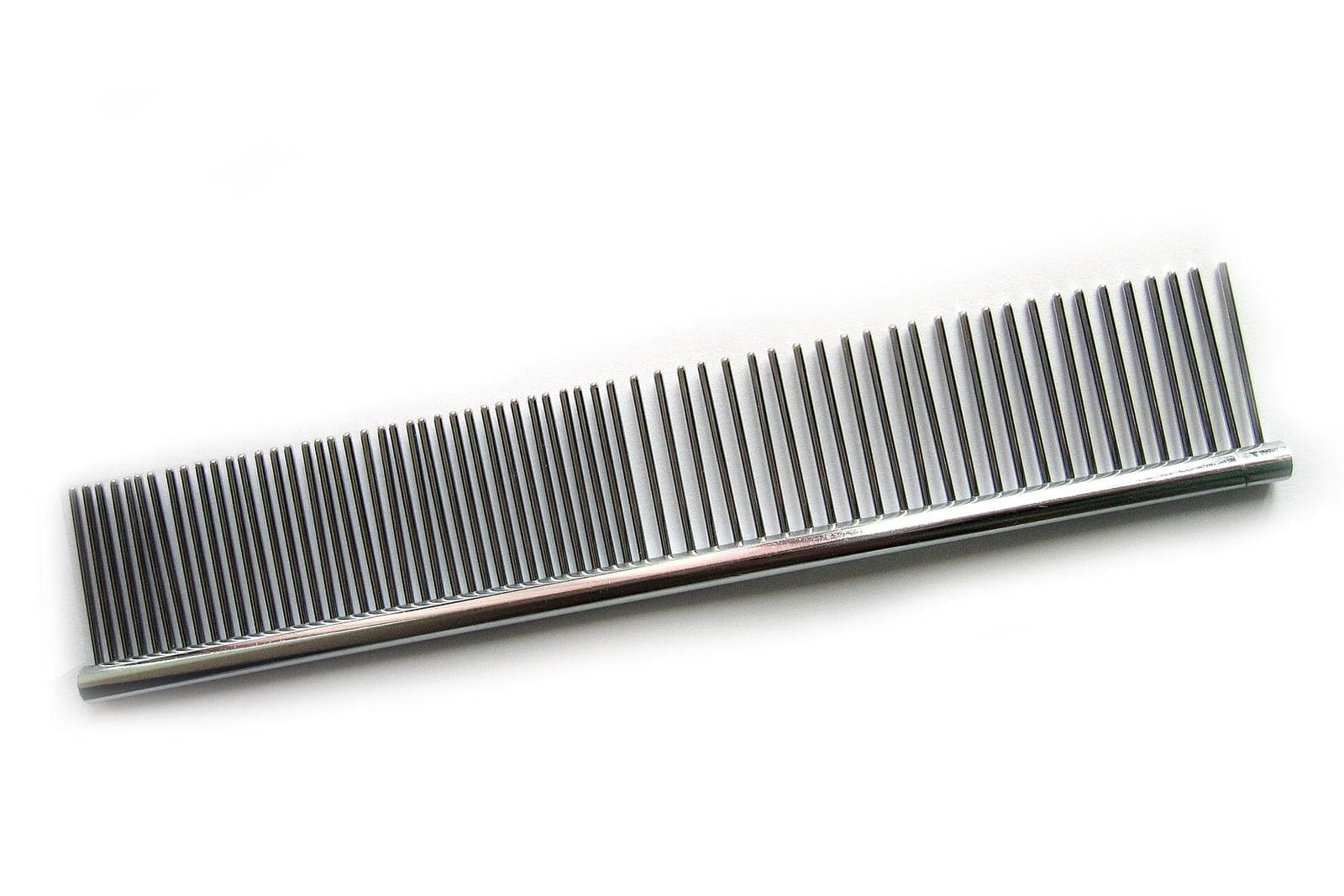 A metal grooming comb with fine and wide teeth on a plain white background