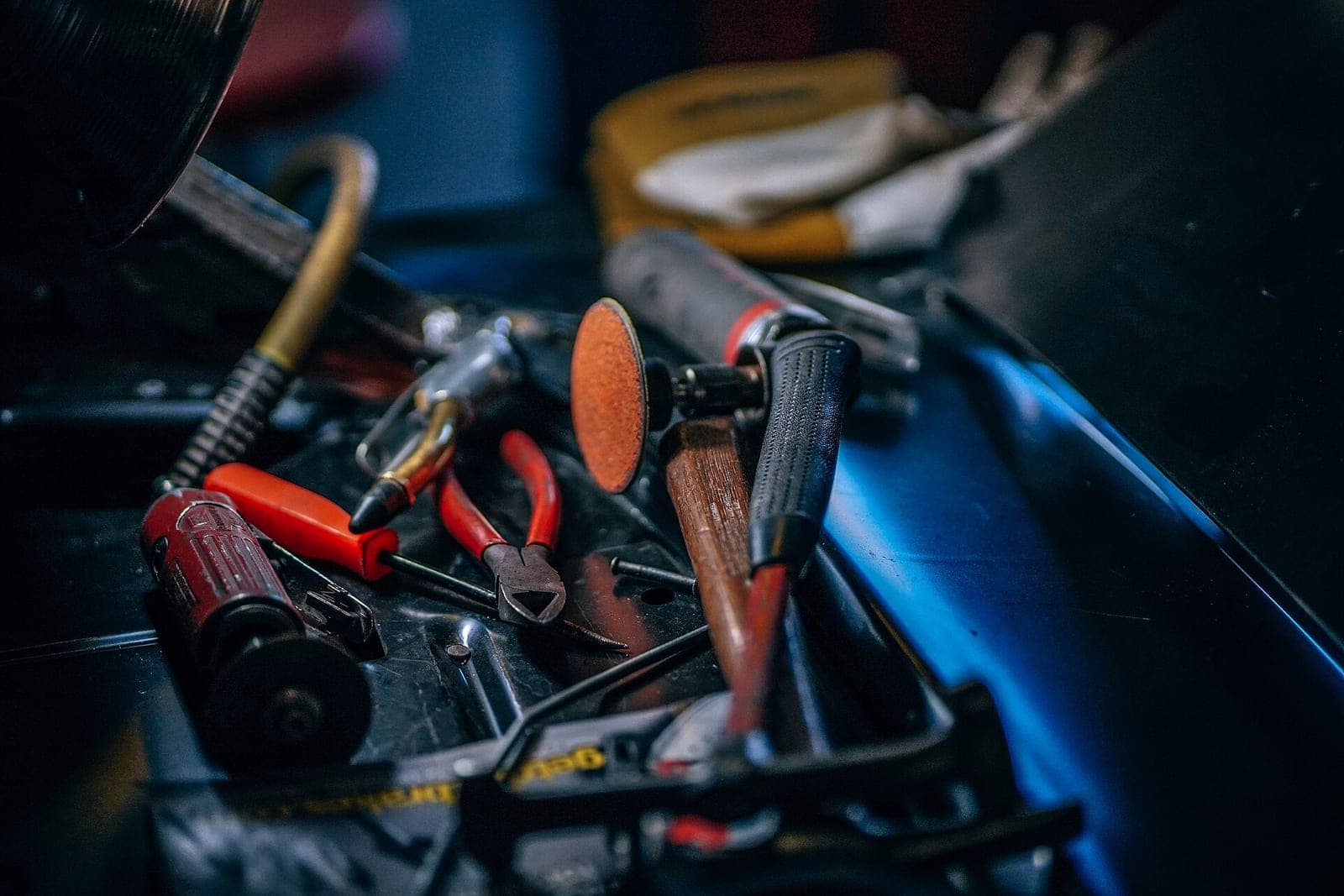 Pliers, screwdrivers and other hand tools piled in a workshop tool tray